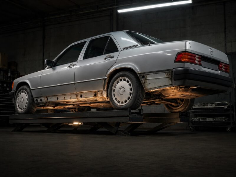 Mercedes 190E with rust damage on the underside and wheel arches.